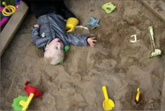  ?? NIKLAS LARSSON, THE ASSOCIATED PRESS ?? Emelie Eriksson’s son Albin plays at the sand pit outside their home in Bergshamra, Sweden. Eriksson was the first woman to have a baby after receiving a womb transplant from her mother.