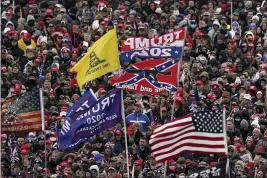  ?? EVAN VUCCI — THE ASSOCIATED PRESS FILE ?? On, Jan. 6, supporters listen to President Donald Trump as a Confederat­e-themed flag and others flutter in the wind during a rally in Washington.