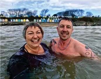  ?? ?? Ella and Matt swim in sunshine and rain on the Suffolk coast