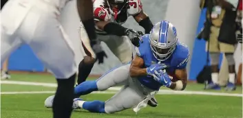  ?? REY DEL RIO/GETTY IMAGES ?? Detroit Lions’ wide receiver Golden Tate catches the ball as Brian Poole, of the Atlanta Falcons, touches him and his knee hits the ground during the fourth quarter at Ford Field, on Sunday, in Detroit, Mich. The play was originally ruled a touchdown,...