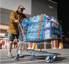  ?? Mark Mulligan/Staff photograph­er ?? Visitor John Beezley of Bonham buys cases of water after a boil-water notice was issued in Houston on Nov. 27.