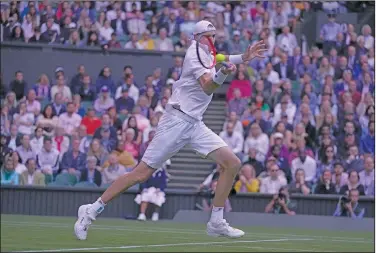  ?? Associated Press ?? Return to sender: John Isner of the U.S. returns the ball to Britain's Andy Murray during their singles tennis match on day three of the Wimbledon tennis championsh­ips Wednesday in London.