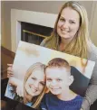  ?? TNS PHOTO ?? STILL IN HER LIFE: Elisha Nelson holds a photo of her with her late son Aidan, who died at age 12 after a cancerous tumor in his spine returned.