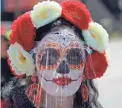  ?? FERNANDO LLANO/AP ?? A woman dressed up as a “Catrina” and wearing a face shield takes part in Day of the Dead festivitie­s in Mexico City on Sunday.