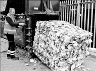  ?? PROVIDED TO CHINA DAILY ?? A worker loads a bail of disposable cups destined to be recycled into new products.