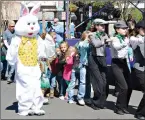  ?? News-Times file photo ?? The Easter Bunny leads people lined up in the Bunny Hop on Washington Avenue during last year’s Shamrockin’ on the Square.