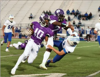  ?? PHOTOS BY MATT BATES — ENTERPRISE-RECORD ?? Oroville’s Isiah Price (10) uses a block from teammate Kacie Riley (7) against Ricky Reyes (2) to break outside Friday during the Tiger’s match up against Orland in Oroville.