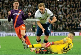  ??  ?? One on one: Kane takes a touch too many as Ederson races to meet him