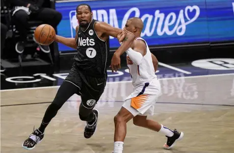  ?? (AP Photo/Kathy Willens) ?? Brooklyn Nets forward Kevin Durant (7) becomes entangled with Phoenix Suns guard Chris Paul during the third quarter of an NBA basketball game, Sunday, April 25, 2021, in New York.