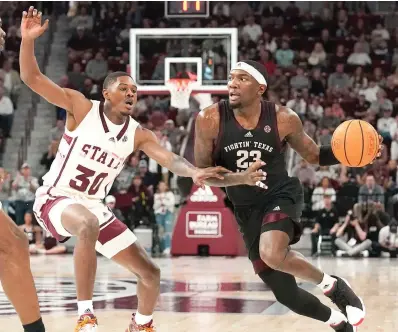  ?? (AP Photo/rogelio V. Solis) ?? Texas A&M guard Tyrece Radford (23) dribbles up court while Mississipp­i State guard Shawn Jones Jr. (30) defends Saturday during the first half of an NCAA college basketball game in Starkville, Miss.
