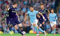  ?? AFP ?? Everton’s Michael Keane (left) vies for the ball with Aguero. —