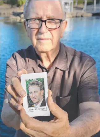  ?? Picture: AP ?? Frank Kerrigan holds a funeral card of his son Frank, who he thought had died. But the coroner's officer had wrongly identified a body as Mr Kerrigan’s son.