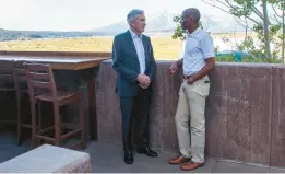  ?? AMBER BAESLER/AP ?? Fed Reserve Chairman Jerome Powell, left, chats with economist Philip Jefferson at the Jackson Hole Economic Symposium on Friday in Grand Teton National Park, Wyo.