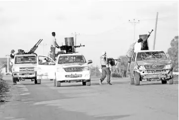  ??  ?? File photo shows armed forces allied to internatio­nally recognised government fight with armed group in Tripoli. — Reuters photo