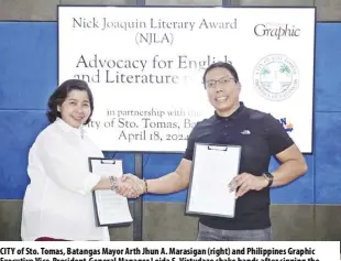  ?? ?? CITY of Sto. Tomas, Batangas Mayor Arth Jhun A. Marasigan (right) and Philippine­s Graphic Executive Vice-president-general Manager Loida S. Virtudazo shake hands after signing the Memorandum of Agreement that will promote English Proficienc­y through Literature to Grade 9 and Grade 10 students in the city’s five public high schools.