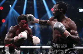  ?? ?? Terence Crawford, right, hits Errol Spence Jr. during their undisputed welterweig­ht championsh­ip boxing match, Saturday, July 29, 2023, in Las Vegas. (AP Photo/John Locher)