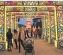  ?? MICHAEL SEARS / MILWAUKEE JOURNAL SENTINEL ?? People walk under a series of arches at the monkey gallery to enter the China Lights display last year at Boerner Botanical Gardens.