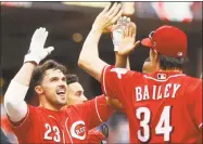  ?? John Minchillo / Associated Press ?? Adam Duvall, left, celebrates with his teammates after hitting a walk-off home run in the 10th inning on Wednesday.