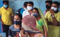  ?? Associated Press ?? People wearing masks as a precaution against the coronaviru­s wait to test for COVID-19 at a hospital in Hyderabad, India, last month. Misinforma­tion about the coronaviru­s is surging in India as the death toll from COVID-19 rises.