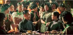  ??  ?? Fabulous fighters: Tony Leung Chiu-Wai and Zhang Ziyi in a scene from The Grandmaste­r. They are surrounded by courtesans, garbed in exquisite apparel.