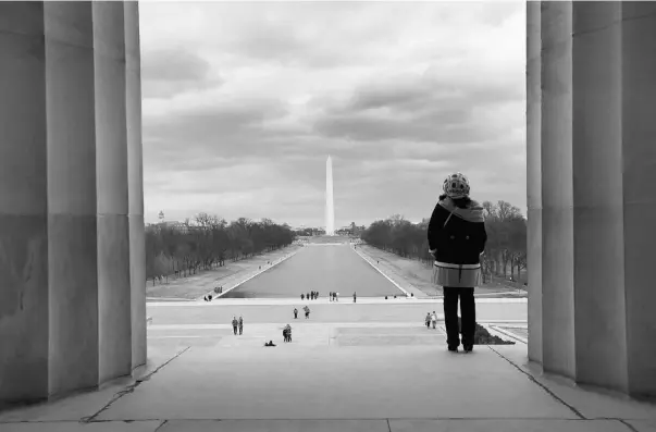  ?? PHOTOS: Alex Brandon/ The Asso
ciat ed Press ?? A visitor views the National Mall from the Lincoln Memorial looking toward the Washington Monument and the U.S. Capitol in Washington.