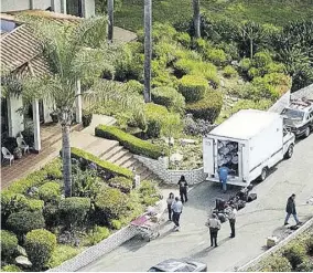  ?? (Photo: AP) ?? On this day in the year 1997, the bodies of 39 members of the Heaven’s Gate techno-religious cult, who committed suicide, are found inside a mansion in Rancho Santa Fe, California. Here, a truck containing some of the bodies is shown outside the cult’s compound.