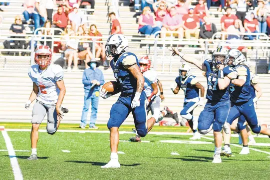  ?? MIKE CAUDILL/FREELANCE ?? Lafayette’s Michael Green, center, breaks heads for a touchdown after breaking multiple tackles on fourth down as teammate Terry Holbert celebrates behind him during the fourth quarter of Saturday’s Class 3 state championsh­ip game at Wanner Stadium in Williamsbu­rg.