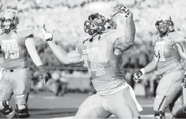  ?? Stephen Spillman / Associated Press ?? Texas Tech’s Kenny Williams celebrates his 50-yard touchdown catch of a pass from quarterbac­k Baker Mayfield that put the first points on the board against TCU on Thursday night in Lubbock.