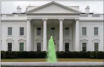  ?? ANDREW HARNIK — THE ASSOCIATED PRESS ?? The fountain on the North Lawn of the White House is dyed green for St. Patrick’s Day.