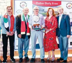  ??  ?? ↑
Winners pose with the organisers after the Dubai Duty Free Golf World Cup.