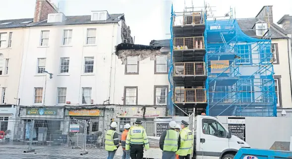  ?? Picture: Gareth Jennings. ?? Police and council officials survey the damaged building after the roof collapse.