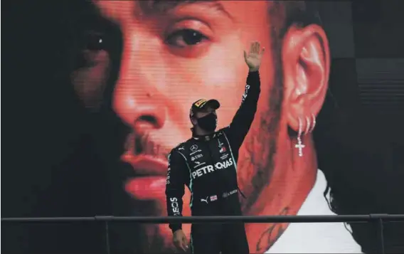  ?? Photo: Jose Sena Goulao/afp ?? Growing a conscience: British driver Lewis Hamilton wants to help preserve the planet with the Extreme E offroad series. Here he celebrates on the podium after winning the Portuguese Formula One Grand Prix.