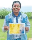  ?? MATHEBULA | RIFUMO ?? HAIRY EYEBALL: Karabo Magakane with a print of one of her photograph­s – an elephant’s eyelash against the yellow background of the bushveld.