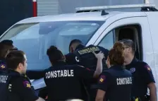  ?? AP ?? EMOTIONAL REACTION: Harris County Pct. 4 deputies provide support to each other at the Harris County Institute of Forensic Sciences after the body of a deputy who was shot and killed was transporte­d to the building, in the van on left, from Memorial Hermann Hospital on Saturday.