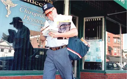  ?? AP FILE PHOTO ?? While most of us remain under stay-at-home orders, postal workers are showing up daily, processing and delivering the nation’s mail.