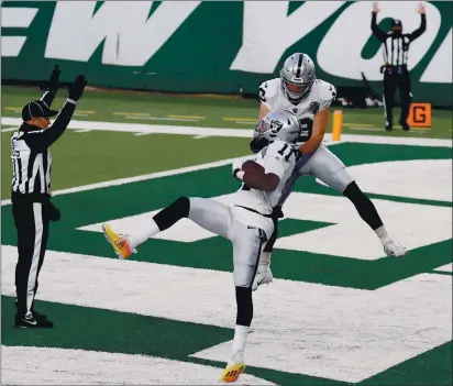  ?? AL BELLO – GETTY IMAGES ?? The Raiders’ Hunter Renfrow, back, celebrates with Henry Ruggs III after Ruggs scored the winning touchdown against the Jets.