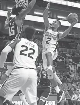  ??  ?? Suns guard Elie Okobo (2) goes up for a layup against the Kings’ Marvin Bagley III during the first half of a preseason game at Talking Stick Resort Arena in Phoenix on Oct. 1.