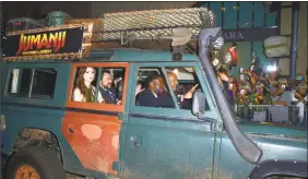  ?? Frederic J. Brown / AFP/Getty Images ?? Kevin Hart and Dwayne Johnson and in rear, Karen Gillan and Jack Black, arrive in a vehicle for the premiere of the film “Jumanji: Welcome to the Jungle.” in Hollywood.