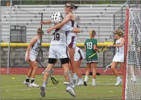  ?? PETE BANNAN - DIGITAL FIRST MEDIA ?? Radnor goalie Alexa Soloman and (14) Julianne Puckette embrace as time expires in the District 1 Class 2A title game. Radnor won 12-6 over Bishop Shanahan at West Chester Henderson High School Thursday.