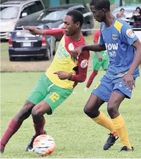  ?? PHOTO BY ASHLEY ANGUIN ?? Green Island High’s Marlando Johnson (left) and Clarendon College’s Damek Fagan (right) battle for possession during their ISSA/Flow daCosta Cup match at Jarrett Park on Wednesday.