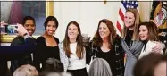  ?? Patrick Semansky / Associated Press ?? Former members and members of the U.S. Women’s National soccer team, from left, Briana Scurry, Margaret ‘Midge’ Purce, Kelley O’Hara, Julie Foudy, and Cindy Parlow Cone, President of U.S. Soccer, pose for a photo with House Speaker Nancy Pelosi of Calif., before an event to celebrate Equal Pay Day and Women’s History Month in the East Room of the White House on March 15 in Washington. The U.S. Soccer Federation reached milestone agreements to pay its men’s and women’s teams equally, making the American national governing body the first in the sport to promise both sexes matching money.