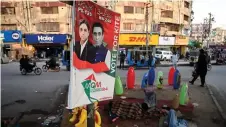  ?? ?? This photograph shows an election campaign poster of the Muttahida Qaumi Movement–Pakistan (MQM-P) party with a portrait of party leader Khalid Maqbool Siddiqui (right) and a candidate for the Sindh provincial assembly Syed Adil Askari, in Karachi.