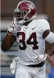  ?? Jonathan Bachman / Getty Images ?? Damien Harris and Alabama are superb at silencing opposing fans with an offense that’s averaging 56.7 points.