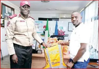  ?? ?? L-R: Federal Road Safety Corps Sector Commander, FCT, Chorrie Isah Muta’a; and JBN Deputy Corporate HSE Manager, Trust Ekaji, during the presentati­on of reflective jackets to the FRSC in Abuja…recently