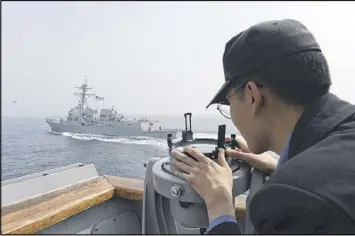  ?? SOUTH KOREAN DEFENSE MINISTRY / VIA AP ?? A South Korean sailor watches the American destroyer USS Wayne E. Meyer take part Tuesday in joint South Korean-U.S. military exercises in South Korea’s West Sea. A U.S. guided-missile submarine arrived in the area Tuesday, and North Korea conducted...