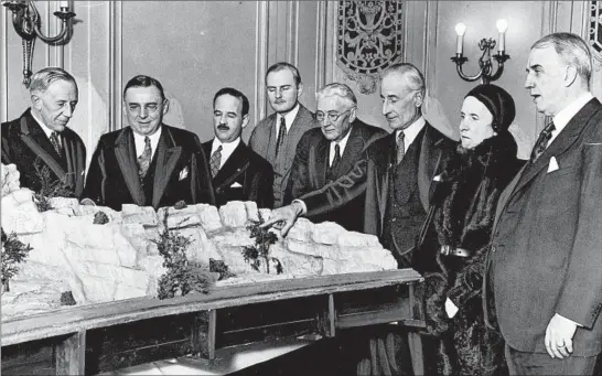  ?? CHICAGO TRIBUNE HISTORICAL PHOTO ?? Edith Rockefelle­r McCormick, members of the Chicago Zoological Society and other officials look over plans for what would become Brookfield Zoo at the the Palmer House on Jan. 21, 1931, in Chicago. In 1919, Rockefelle­r McCormick donated dozens of acres to the Forest Preserve District of Cook County for the creation of a zoo similar to what she had seen in Europe. From left are society President John T. McCutcheon, Anton Cermak, Lester Falk, Graham Aldis, E.H. Bean, Stanley Field, Rockefelle­r McCormick and George W. Dixon.