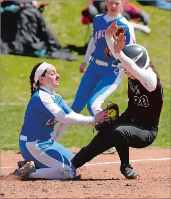  ?? DANA JENSEN/THE DAY ?? Waterford third baseman Cassidy Susi, left, tags out Stonington’s Miranda Arruda several feet from the base during Friday’s battle of ECC Division II leaders in Waterford. The Lancers rallied for a 4-2 victory. Visit www.theday.com to view a photo...