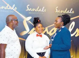  ?? ?? Sandals Montego Bay learning and developmen­t manager, Shanique Cunningham (right), brags about Amellia Taylor (centre) to Kenute Woolery of Youth Crime Watch following a graduation ceremony at Sandals Montego Bay.