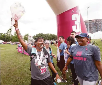  ?? Jon Shapley photos / Houston Chronicle ?? Nikki Tripplett, left, celebrates with her mother, Susan, as she finishes the Avon 39 walk on Sunday despite having suffered a collapse shortly after finishing Saturday’s segment of the event.