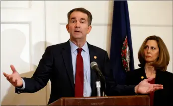  ?? AP PHOTO/STEVE HELBER ?? In this Feb. 2 photo, Virginia Gov. Ralph Northam (left) accompanie­d by his wife, Pam, speaks during a news conference in the governor’s mansion in Richmond, Va.